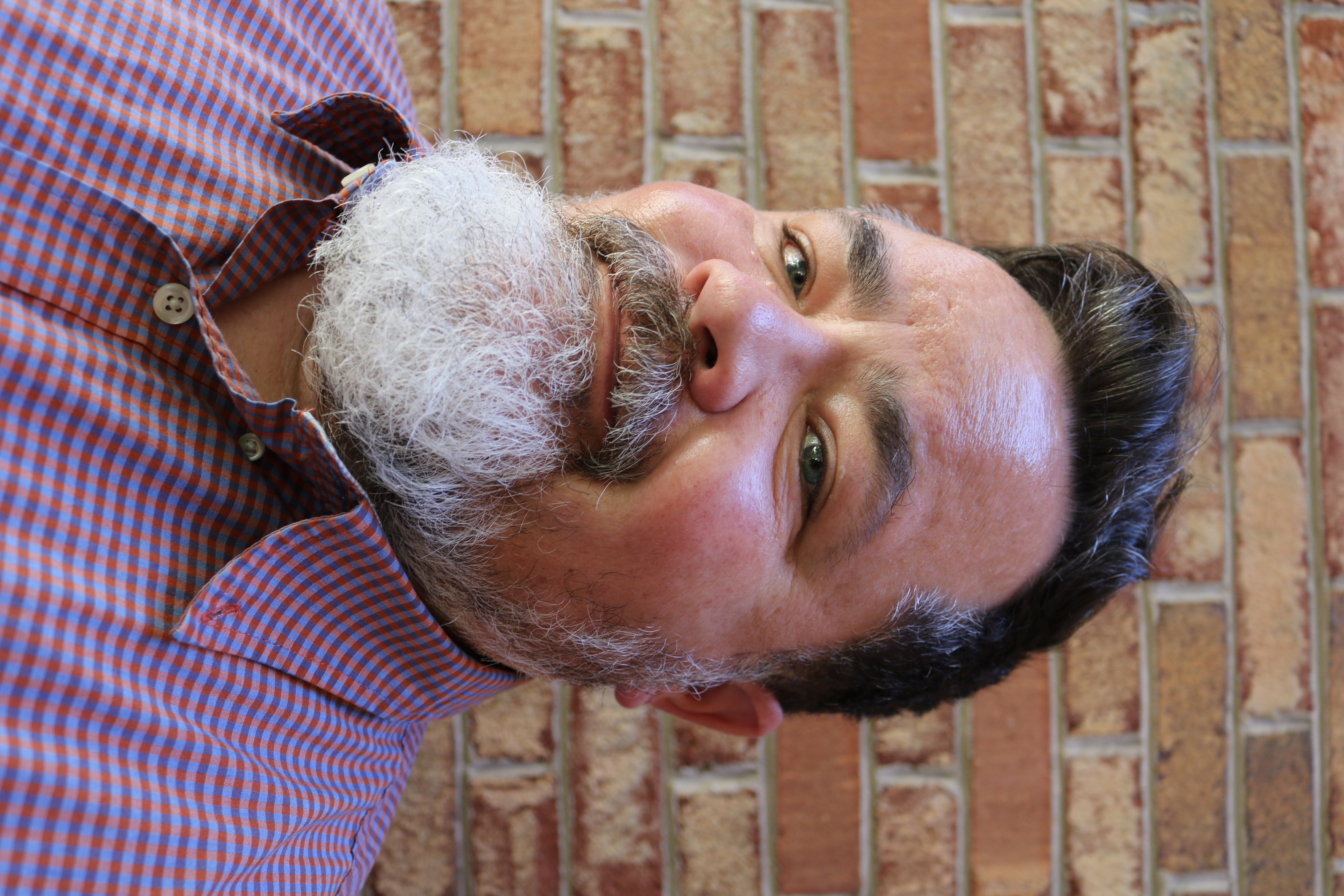 A person with a beard  AI-generated content may be incorrect.